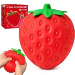 Giant jumbo strawberry squishy squeeze toy on a desk — Image 1 of 10
