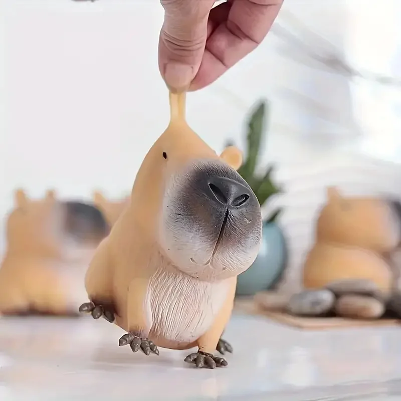 Soft capybara squishy toy squeezed in a hand — Image 4 of 7